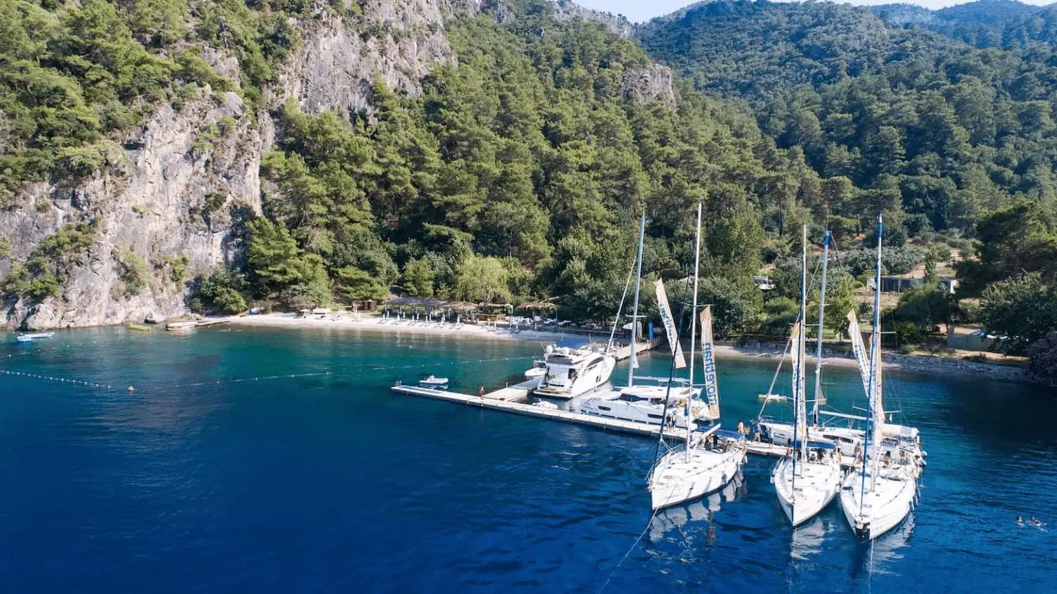 Sailing yachts and gulets anchored in Turunç Pınarı Bay, Fethiye.