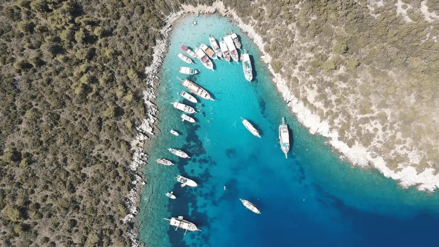 A gulet and a catamaran anchored off Orak Island in Bodrum.